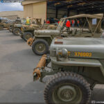 Jeeps lined up with a P-51A Mustang at the 2024 Wings, Tracks, and Wheels Event